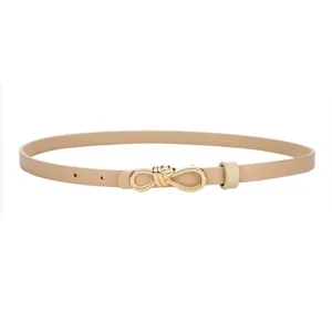 Elegant slim women leather belt detail showing chic gold bow buckle in versatile beige style.