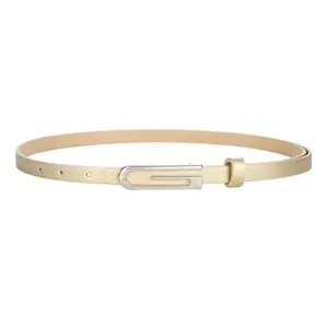 Primer plano detalle de un cinturón dorado delgado para mujer con hebilla plateada.