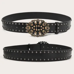Vintage black leather belt with ornate rhinestone floral buckle and metallic stud detailing.