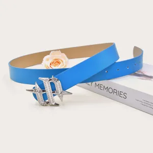 Detailed view of a vibrant blue leather belt featuring a dazzling rhinestone metal buckle.
