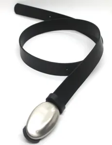 Closeup detail of a black leather belt with a sleek oval metallic buckle, minimalist style.