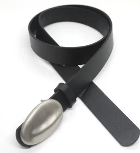 Close-up detail of the black leather belt featuring a smooth oval metal buckle design.