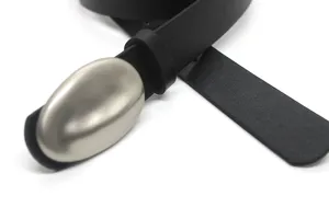 Minimalist black leather belt featuring a unique oval metal buckle. Detailed close-up view.