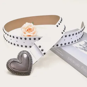 Detail shot of white PU leather studded belt featuring a vintage metal heart buckle and rivets.