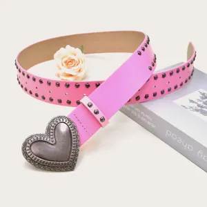 Pink PU leather belt featuring a vintage silver-tone heart buckle and metal stud details.
