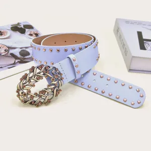 Womens vintage rhinestone belt with carved buckle and studs, blue leather accessory.