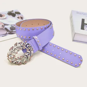 Detailed close-up view of the purple rhinestone belt featuring an intricate ornate buckle and studs.