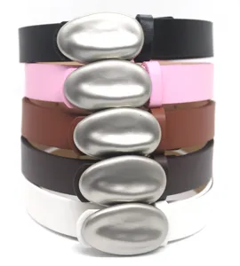 Close-up of stylish stackable leather belts featuring unique metal pebble buckles in multiple colors.