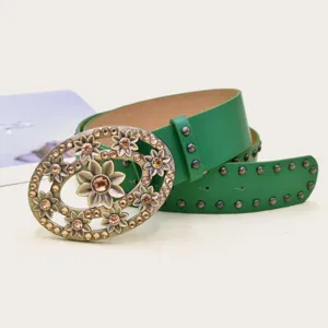 Detail view of a vintage green leather belt with an ornate rhinestone floral buckle and studs.