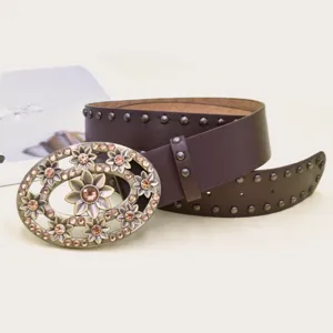 Women's vintage rhinestone flower belt detail, brown leather with decorative oval buckle.