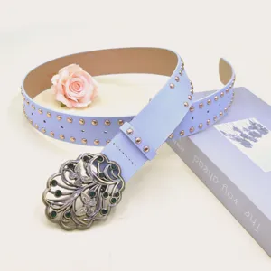 Y2K punk style wide leather belt featuring metallic studs and an ornate butterfly buckle detail.