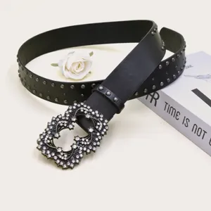 Fashion punk style wide leather belt with metal studs and sparkling rhinestone ornate buckle.