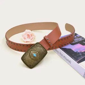 Close-up detail of the vintage brown studded belt featuring an ornate metal buckle with blue stone.