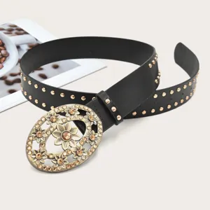 Detailed view of the women's vintage cutout rhinestone flower oval buckle black belt closeup.