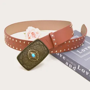 Detailed shot of vintage brown leather wide belt featuring ornate metal buckle with blue stone and studs.