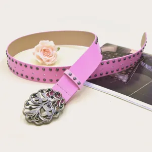 Pink Y2K punk wide leather belt featuring vintage metal buckle and dark stud details.