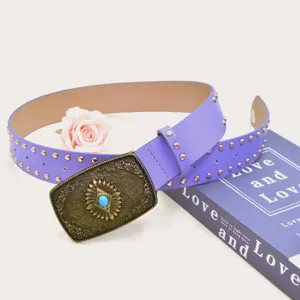 Close-up detail of vintage purple wide leather belt with ornate brass buckle and studs.