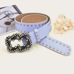 Close-up detail of the light blue studded women belt with rhinestone vintage buckle decoration.