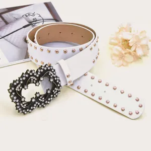 White PU leather belt featuring vintage rhinestone heart buckle and metallic stud accents.