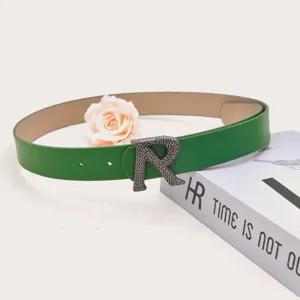 Green PU leather women belt featuring a metallic textured R buckle for stylish daily outfits.