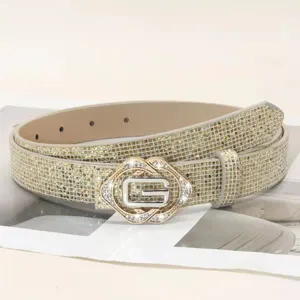 Close-up details of the sparkling rhinestone women belt with stylish metal G buckle design.