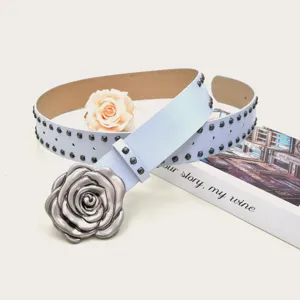 Gros plan détaillé de la ceinture en cuir bleu clair punk avec boucle rose argent vieilli.