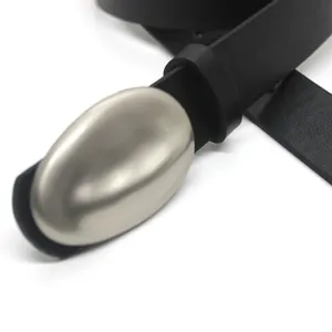 Minimalist black leather belt with unique sculptural oval metal buckle for women.
