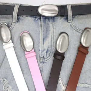 Trendy leather belt with unique oval metal buckle, versatile waist accessory for jeans and dresses.