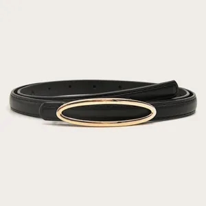 Detail zwarte smalle damesriem, elegante gouden ovale gesp als accessoire voor jeans en broek.
