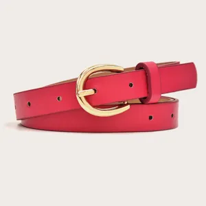 Close up of a red leather women belt featuring a stylish gold horseshoe metal buckle detail.