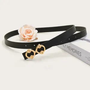Detailed shot of a stylish black leather belt with a luxury gold-tone double circle buckle.