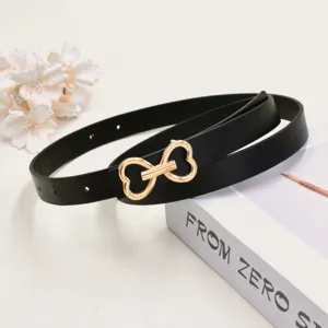 Detail shot of a stylish black women's belt featuring a polished gold-toned double heart buckle.
