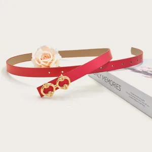 Red thin leather belt detail featuring a stylish gold double ring buckle, elegant fashion accessory.