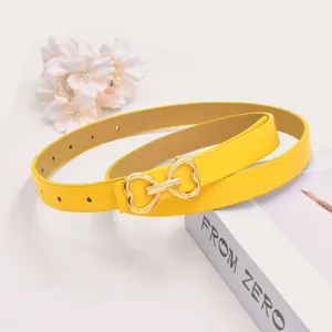 Yellow women leather belt featuring a cute gold heart buckle, perfect for pants and dresses.