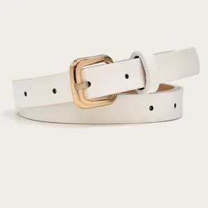 Close up shot of a stylish white leather belt showing the golden metal pin buckle.