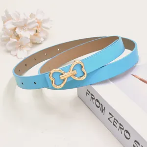 Close-up of blue leather belt with gold heart buckle, stylish accessory detail shot for summer.