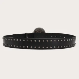 Detail view of black leather belt featuring double row metal studs and punk style buckle.