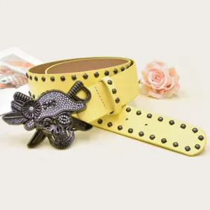Yellow leather women belt with rhinestone skull buckle and black metal studs for Y2K rock style.