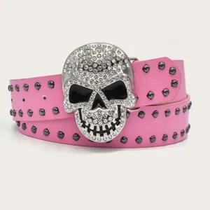 Close-up detail of a pink rhinestone skull belt with metal studs, punk style fashion accessory.