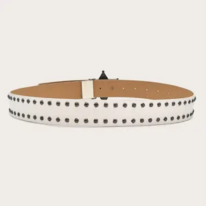 Close-up of white leather belt detail featuring double rows of dark metal rivets and star buckle.