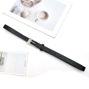 Detailed shot of a sleek black PU leather thin belt featuring a polished silver pin buckle.