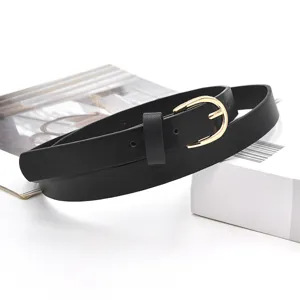Details of the classic black slim leather belt featuring a stylish gold buckle for women.