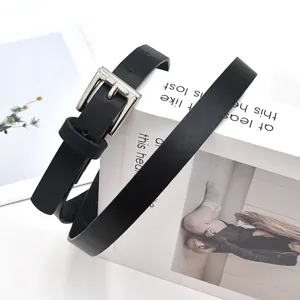 Simple minimalist black leather belt for women with silver pin buckle for daily wear.