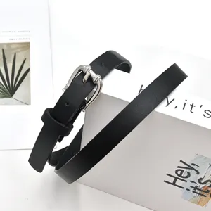 Detail shot of a minimalist black PU leather women belt with silver metal buckle, casual style.