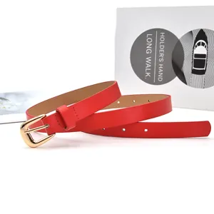 Detailed view of stylish red thin women belt featuring a shiny gold pin buckle for dresses.