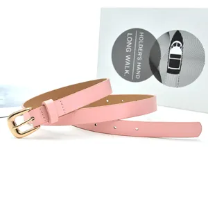 Detailed view of women pink belt with gold pin buckle, elegant accessory for dress jeans.