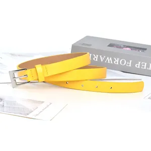 Yellow leather belt for women, simple thin dress waist accessory detail close view.
