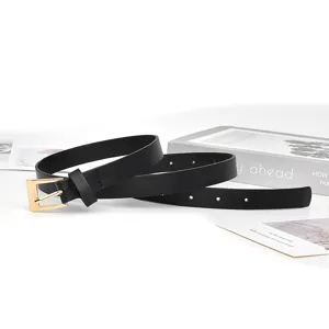 Close-up detail of a minimalist black thin leather belt with gold square buckle for women styling.