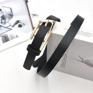 Close-up detail of black slim belt with gold buckle, showing premium texture and design.