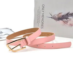 Pink women's thin leather belt with gold metal buckle, simple casual jeans belt detail shot.